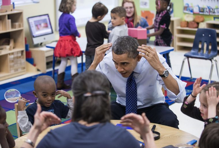 President Obama plays a learning game while visiting children at College Heights Early Childhood Learning Center in Decatur.