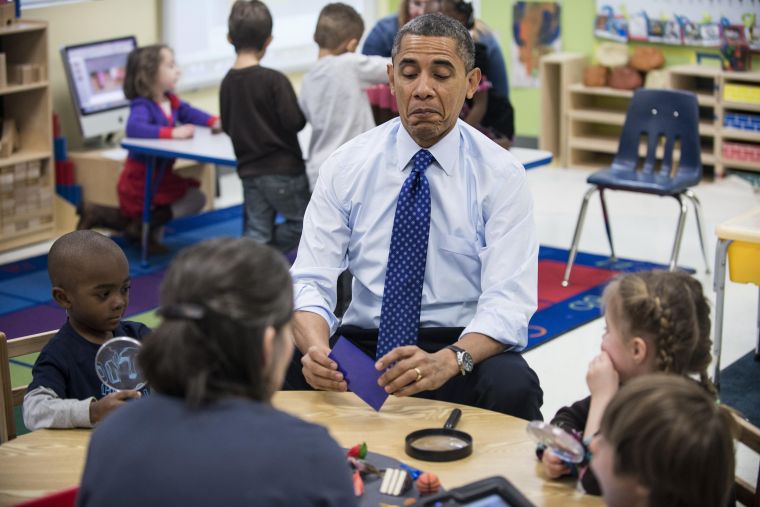 President Obama plays a learning game while visiting children at College Heights Early Childhood Learning Center in Decatur.