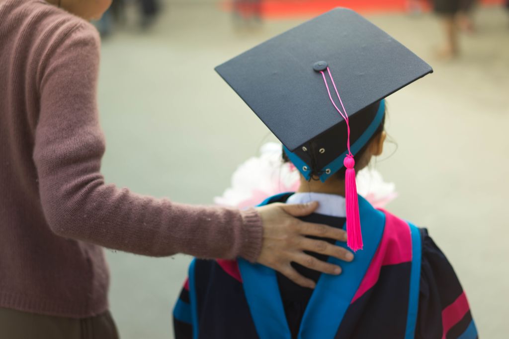 Kindergarten graduate, mom and child