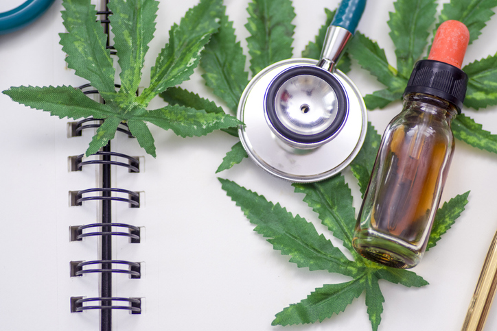 Marijuana research, The doctor holds a bottle of marijuana.