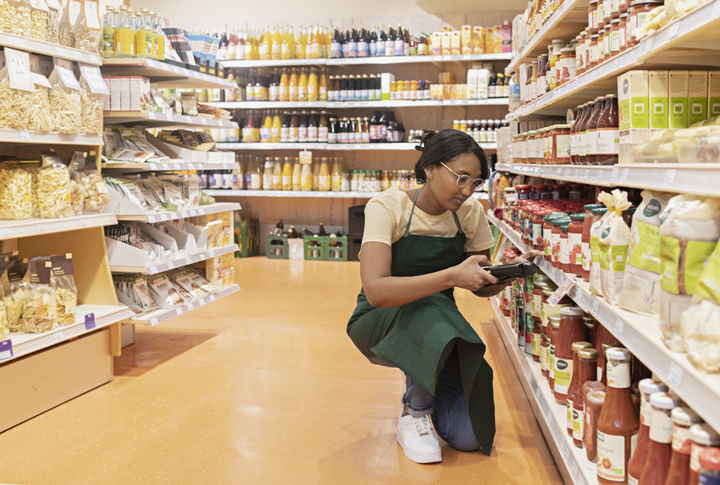 supermarket employee ordering groceries, using bar code reader