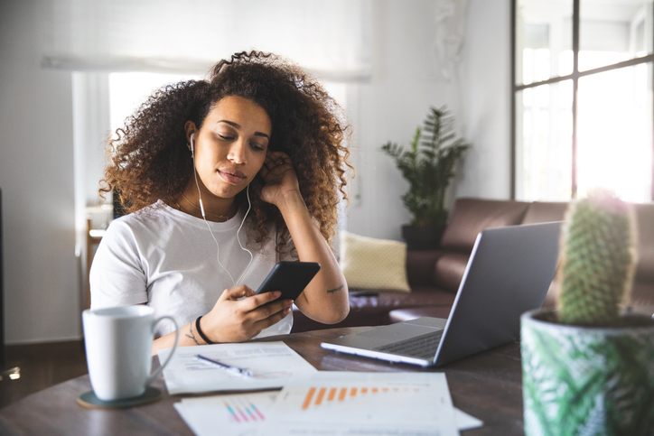 Pregnant woman having a work video call with colleagues