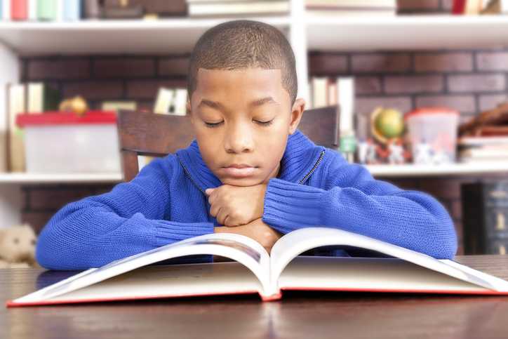 Elementary age students in classroom or library at school.