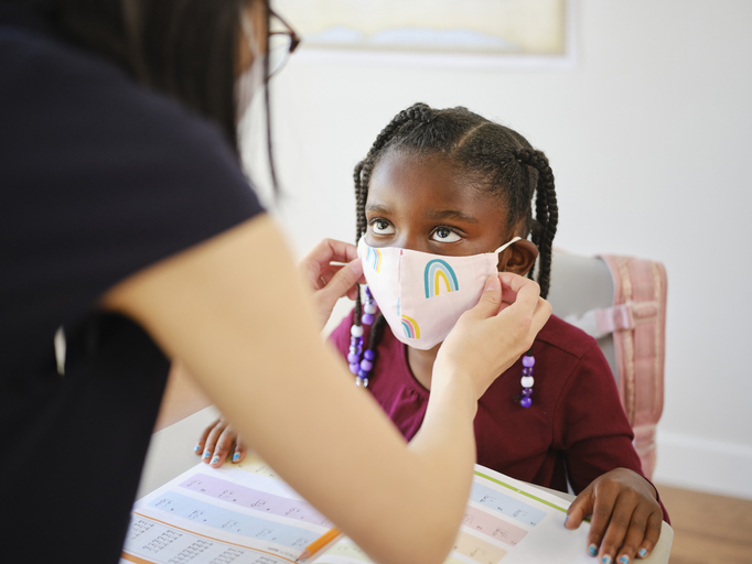 An Elementary School Student and Teacher in a Classroom