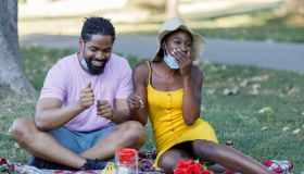 Happy Young African Couple is Having a Picnic Outside in Nature During a Virus Time.