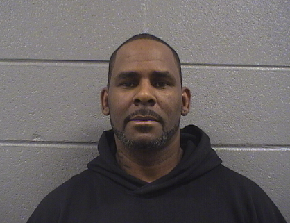 Headshot of a middle-aged Black man with a serious expression, wearing a black hooded sweatshirt.